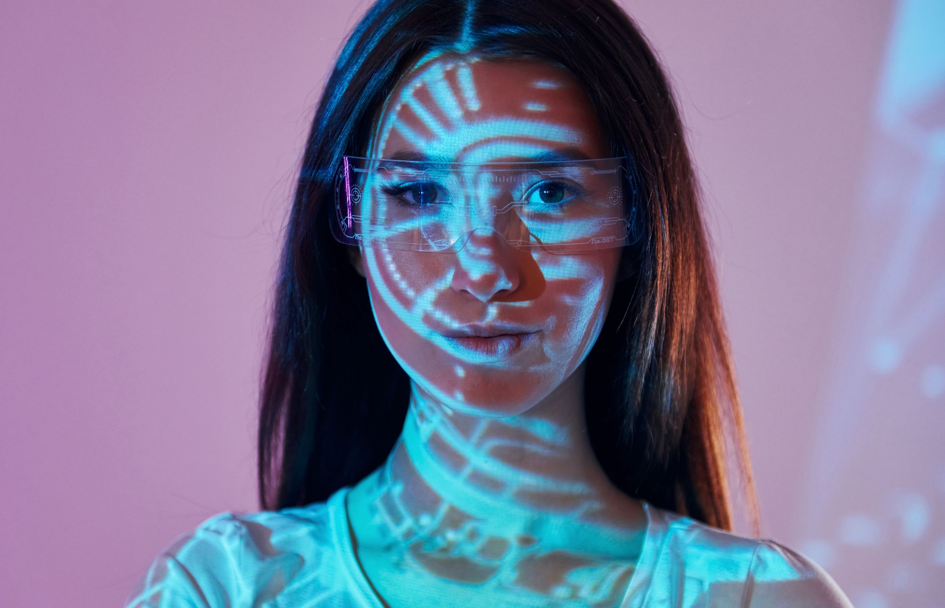 Abstract picture. Beautiful young woman is in projector neon lights in the studio